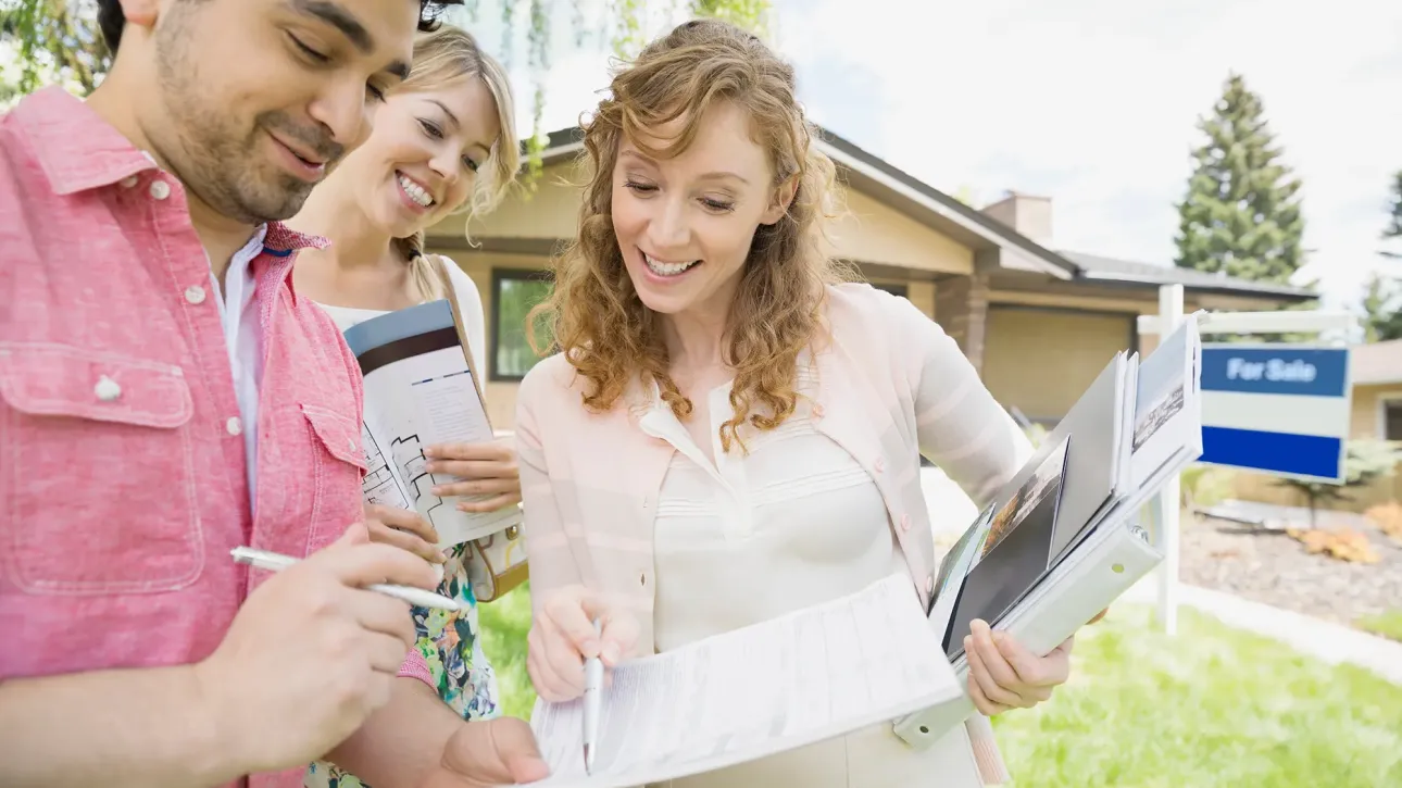 Homeowner providing maintenance documentation to real estate agent before closing