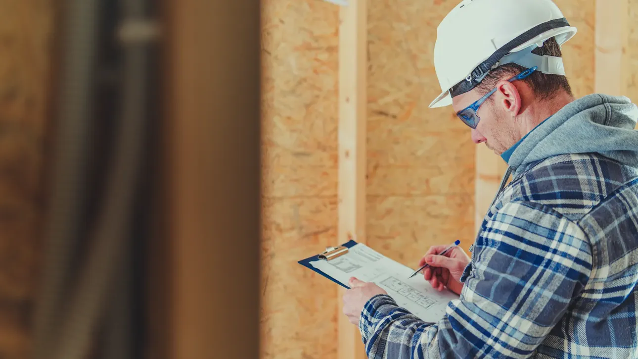 Home inspector documenting repair issues during pre-closing property inspection