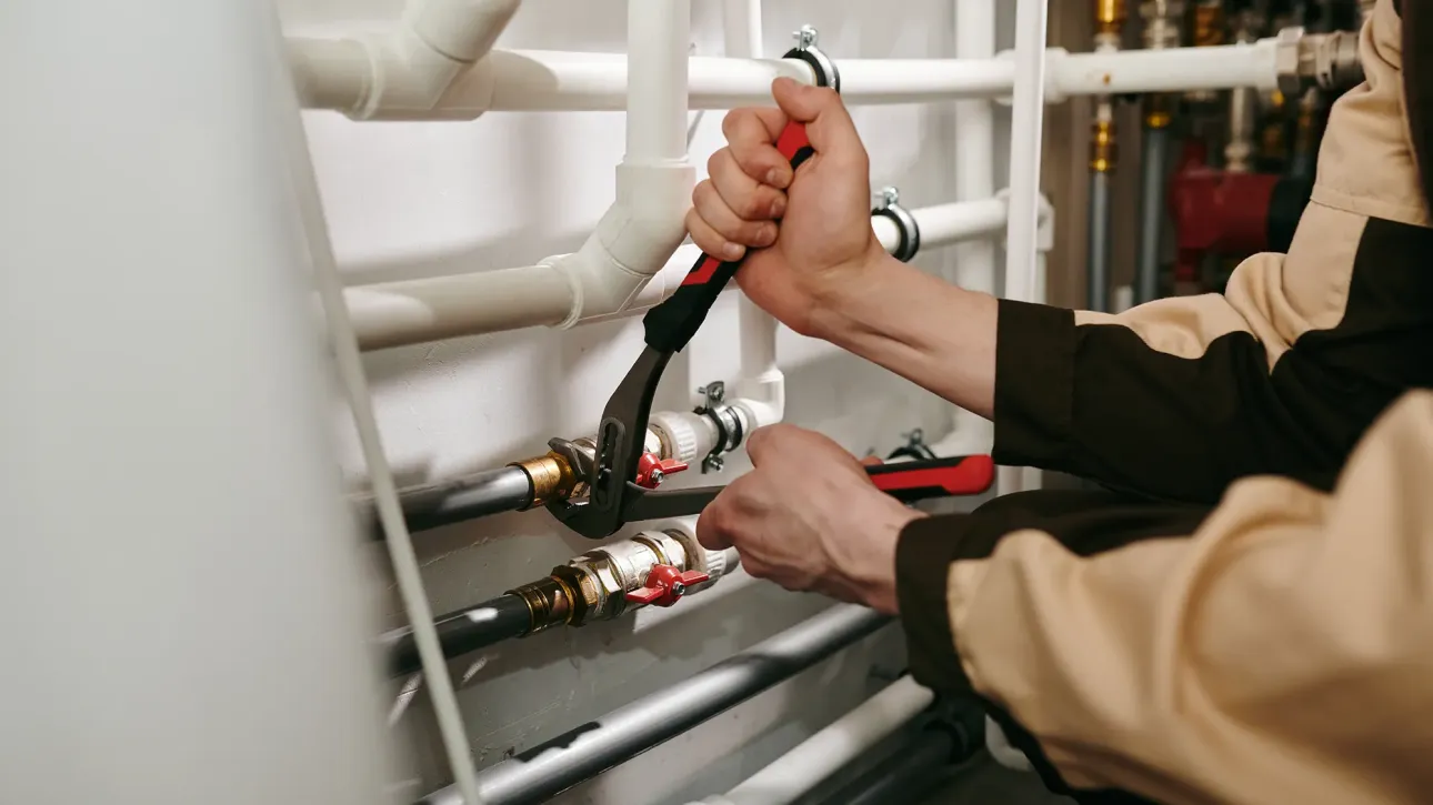 Contractor performing final quality check on plumbing repair before home re-inspection in Texas