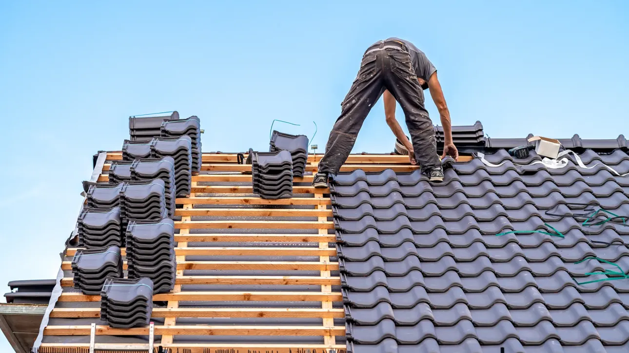 Roofing contractor evaluating functional hail damage on DFW home shingles during post-inspection repair assessment before closing