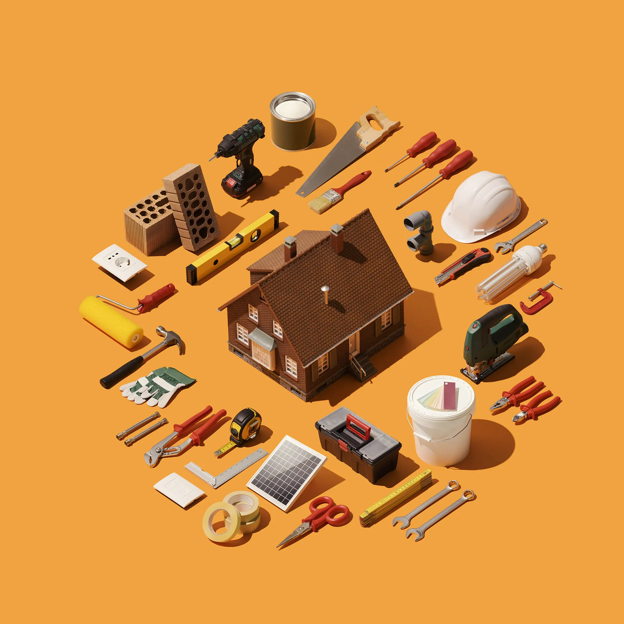 Home repair tools arranged around a small house