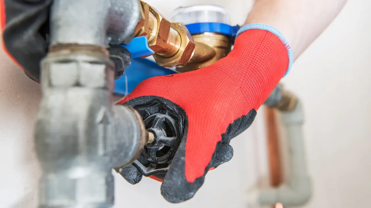 Plumber replacing water heater pressure relief valve to resolve Texas home inspection finding before closing