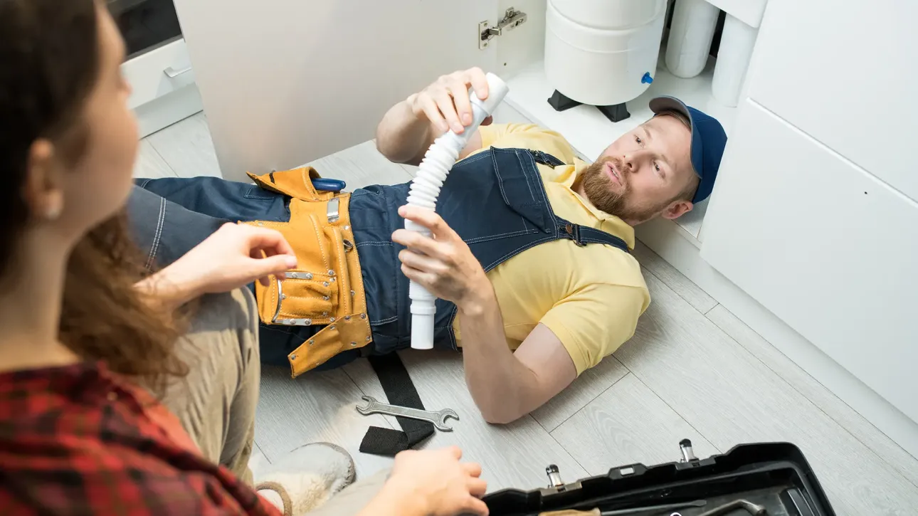 Licensed plumber completing post-inspection repair in Texas home before closing deadline.